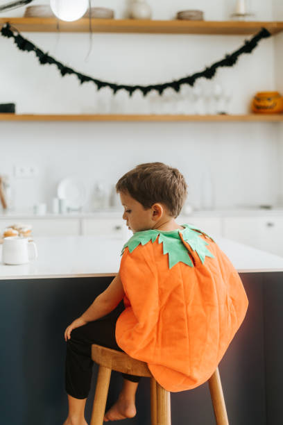 Boy wearing pumkin costume