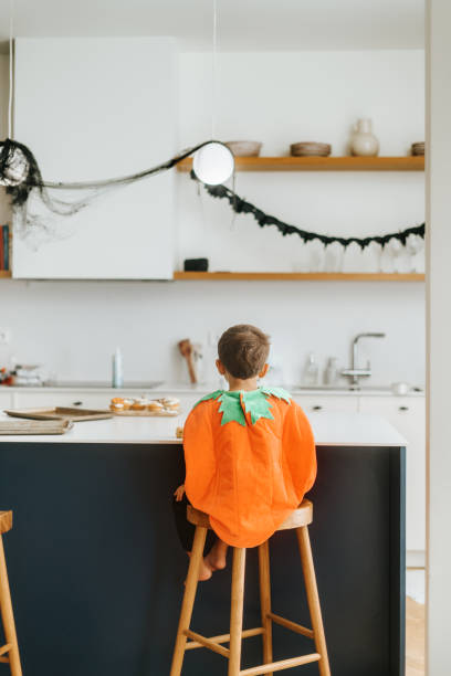istock Boy wearing pumkin costume 2180196557