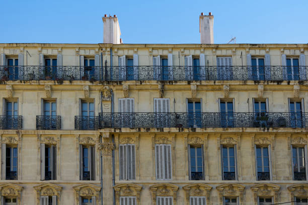 facades of buildings on a street in Marseille, France. The architecture reflects the rich history and charm of this Mediterranean city, making it a delightful visual experience.