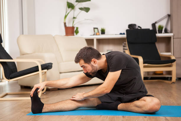 istock Young man practicing yoga in his living room 2180202065