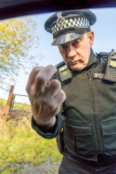 African american security agent indicating the direction for persons, working as a patrol officer against blue background. Bodyguard pointing at an access way to the left or right sides.