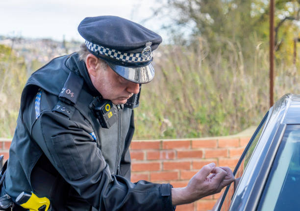 istock UK police officer approaching a parked car 2180202412