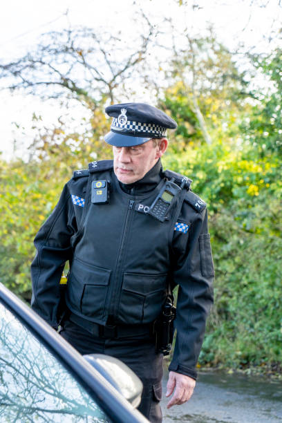 istock UK police officer approaching a parked car 2180202554