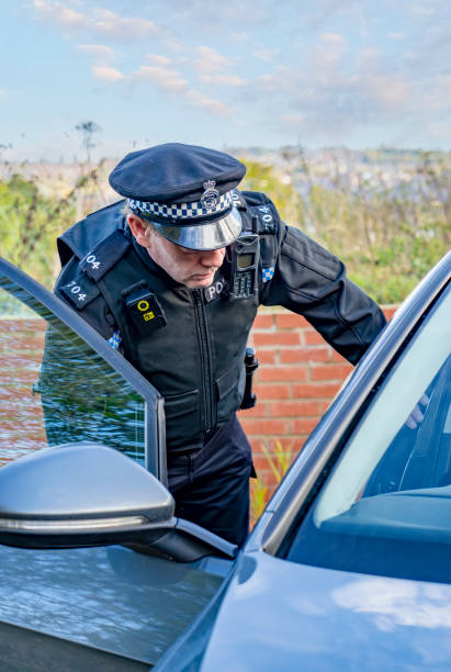 istock UK police officer approaching a parked car 2180203352