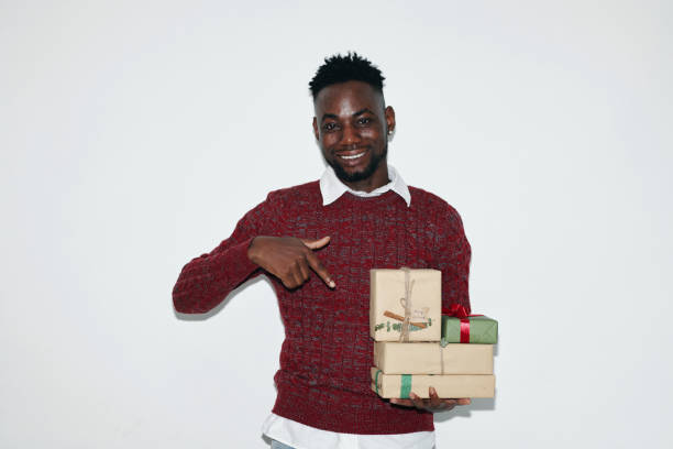 istock Smiling Man Holding Wrapped Gifts with White Background 2180203728