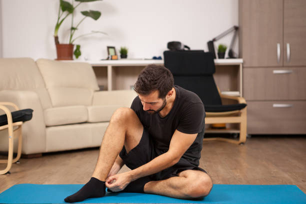 istock Young man practicing yoga in his living room 2180203793