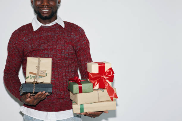 istock Smiling Man Holding Festive Gift Boxes with Joy 2180203797
