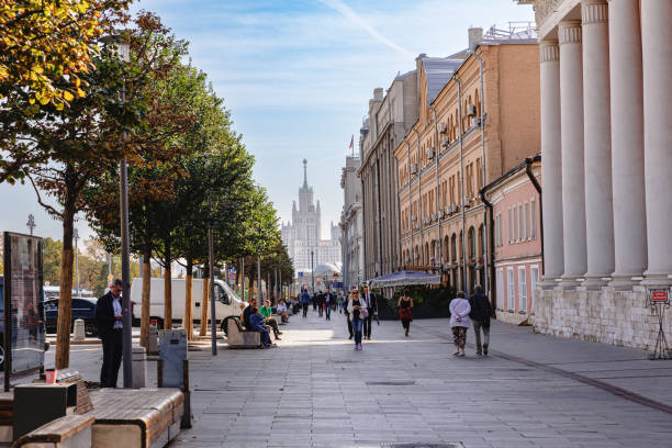Moscow, Russia, September 29, 2023: People walking in stone paved pedestrian zone with old architecture on a fine day