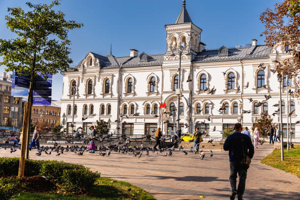 Moscow, Russia, September 29, 2023: Beautiful old public building in the park with pigeons on a clear day
