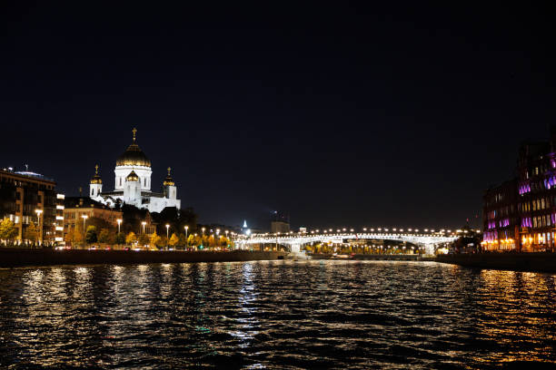 Moscow, Russia, September 28, 2023: The Moskva River at night with illuminated bridge and church Temple of Christ the Savior