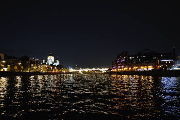 Moscow, Russia, September 28, 2023: The Moskva River at night with illuminated bridge and church Temple of Christ the Savior