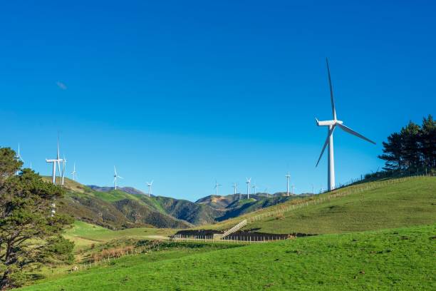 istock Wind turbines on a green hill under a blue sky. 2180206100