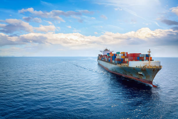 istock Panoramic front view of a large cargo ship carrying containers for import and export 2180206576