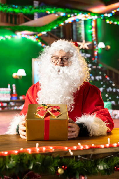 istock Saint Nicholas decorates many presents with ribbons and bows 2180206882