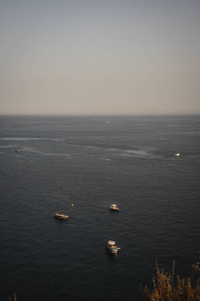Mediterranean sea with boats and surfer