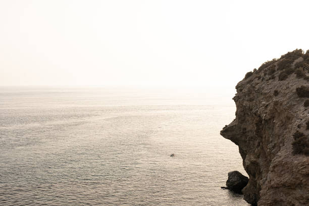 Mediterranean sea with boats and surfer