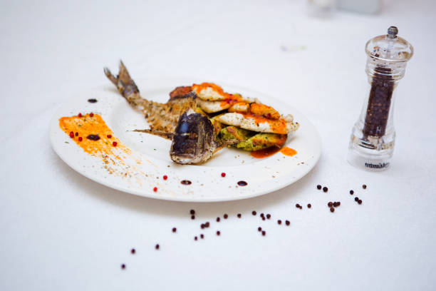 Plate of fish with vegetables and spices