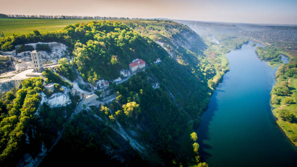 istock A Serene River Flowing Through a Vibrant, Lush Green Forest. A river running through a lush green forest 2180212342