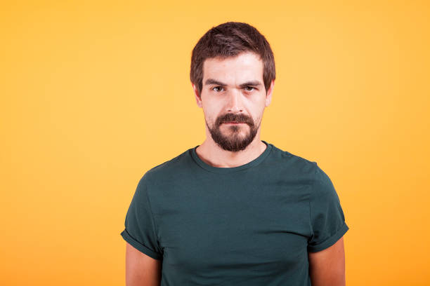 istock Grumpy stressed worried man on yellow background lookin at the camera 2180212932