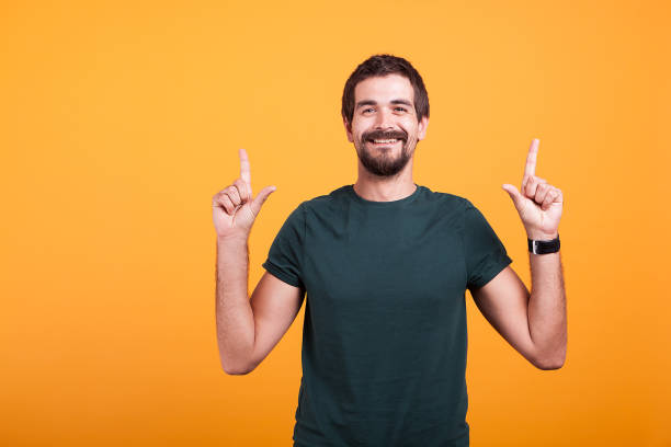 istock Happy man smiling and pointing up with his fingers 2180213070