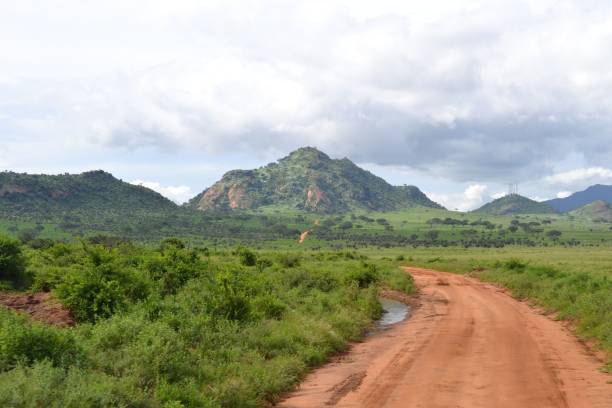 istock Scenic road to green mountain under cloudy sky 2180213126
