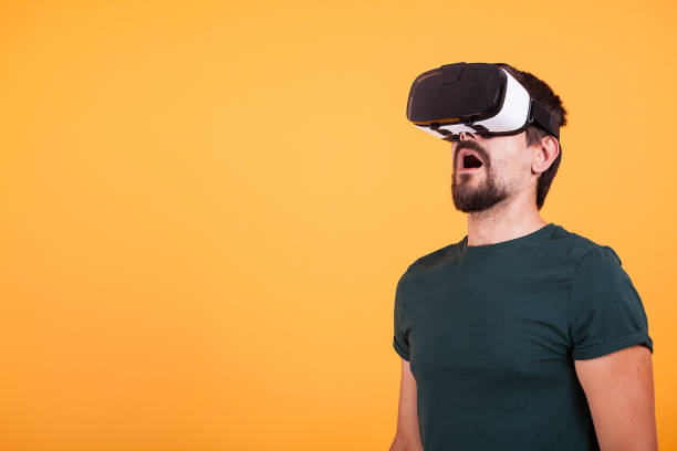 istock Man wearing VR virtual reality headset is amazed 2180213523