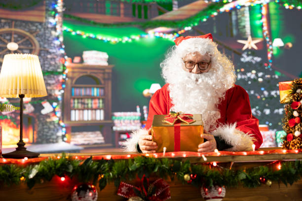 istock Saint Nicholas prepares a festive gift box by the fire 2180213940