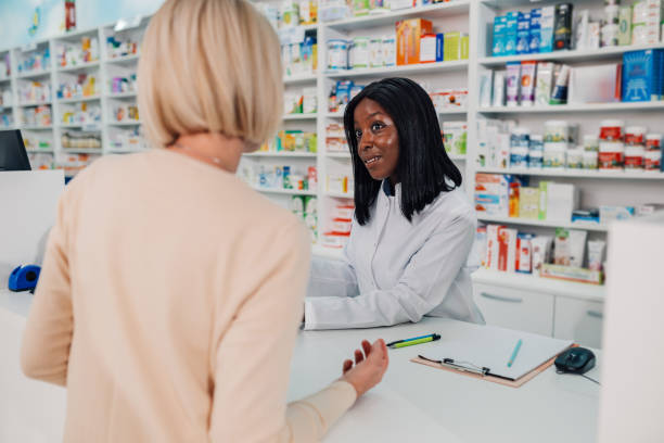 istock Pharmacist assisting a customer in a modern pharmacy 2180213981