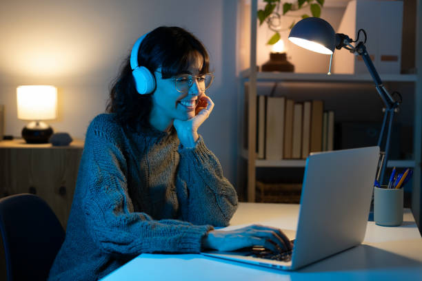 istock Caucasian woman working late at night with computer at home. 2180214713