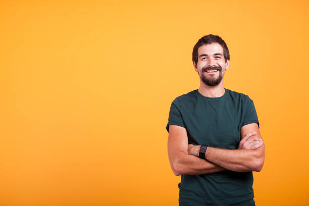 istock Handsome man with his arms crossed smiling at the camera 2180214723