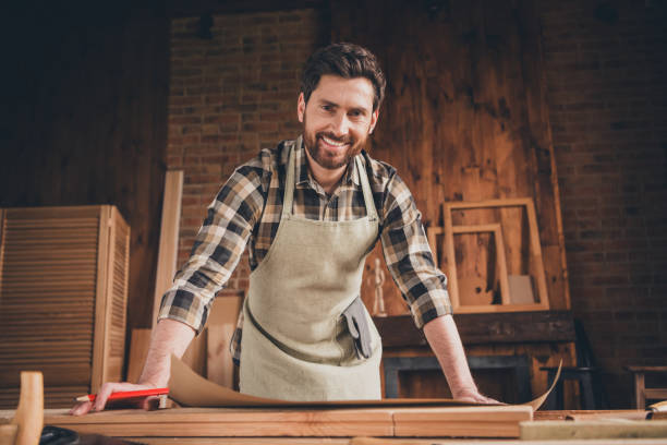 istock Photo of professional builder guy look smiling writing plan blueprint in garage 2180215163