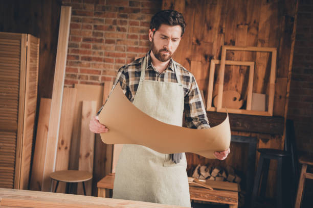 istock Photo of professional workman guy open scheme read look learn in garage indoors 2180215182