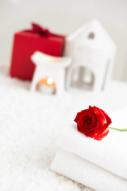 istock White towels with red rose and candle 2180216636