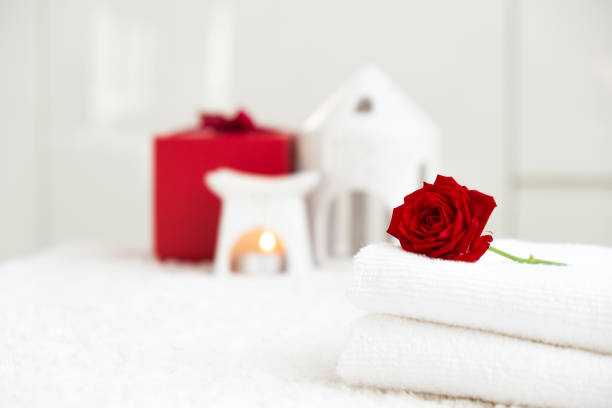 istock White towels with red rose and candle 2180216692