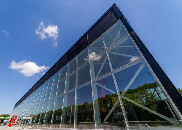 istock Modern building with glass facade and blue sky in the background 2180217975