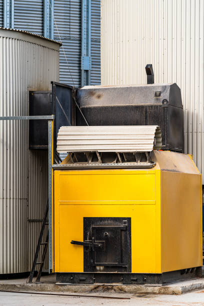 istock Yellow industrial boiler stands outside warehouse 2180219225