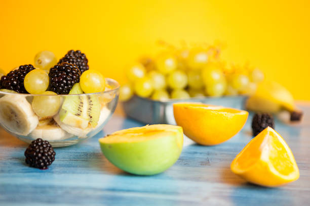 A wooden table with pineaple ,strwaberry and exotic fruits. Organic light fruits variation