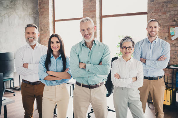 istock Photo of teamwork people working together  confident posing crossed hands comfortable modern office loft room interior indoors workspace 2180219909