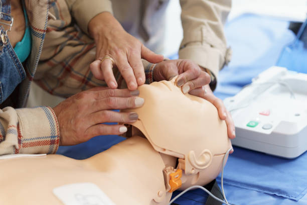 istock Latina woman learning the CPR technique on a mannequin during a first aid course. 2180220227