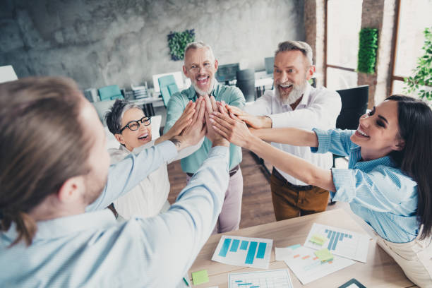 istock Photo of teamwork people working together highfive teamwork hold hands comfortable modern office loft room interior indoors workspace 2180220265