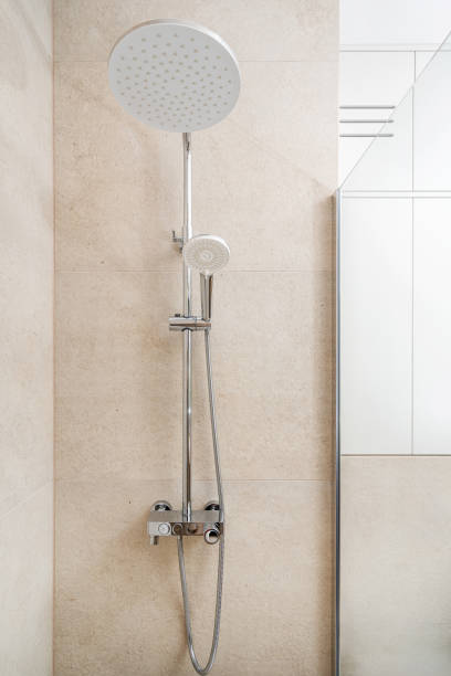 istock Modern shower fixture with overhead and handheld options in a sleek bathroom setting 2180221282