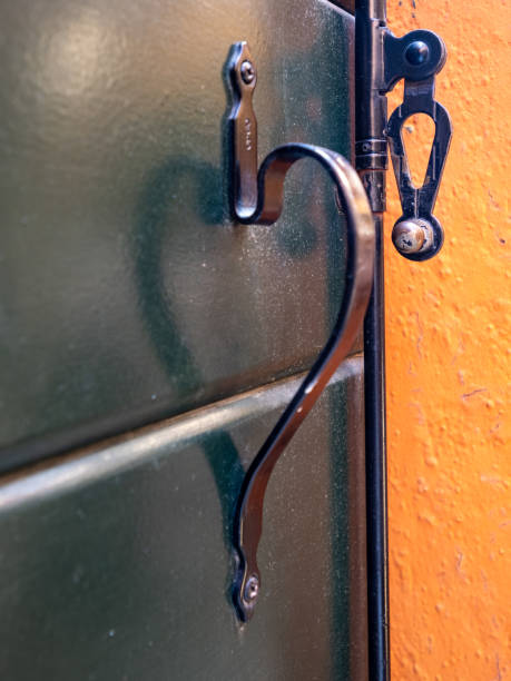 Half heart shaped window handle in Burano, Italy. Burano is an island in the Venetian Lagoon, known for its brightly coloured homes.