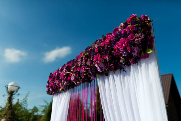 istock Beautiful wedding arch with flowers on the sky background 2180222037