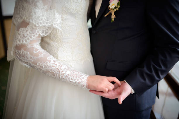 istock Bride and groom holding hands on their wedding day 2180222111