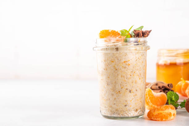 Tangerine creamsicle Overnight Oats, sweet breakfast oatmeal with creamsicle and fresh tangerine slices, spices and orange peel
