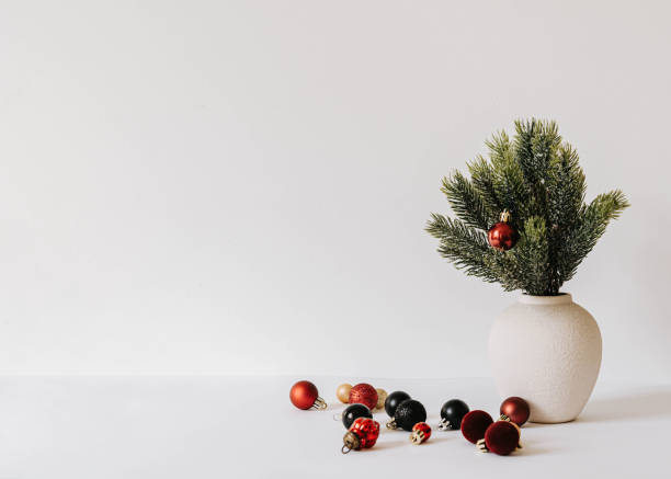istock Minimalistic Christmas composition with fir branches in ceramic vase on white background 2180223705