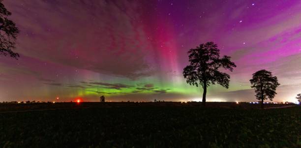 istock Aurora borealis over a silhouetted landscape. 2180225519