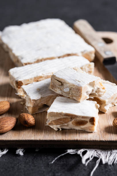 istock Christmas almond nougat on black slate background 2180225959