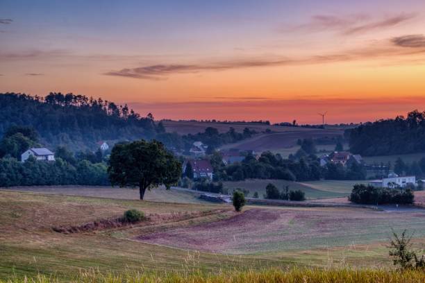 istock Scenic rural landscape at sunset with fields and trees. 2180226036