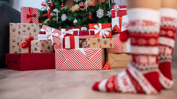 istock Beautiful gift boxes under a modern Christmas tree in a home, adorned Xmas 2180227581